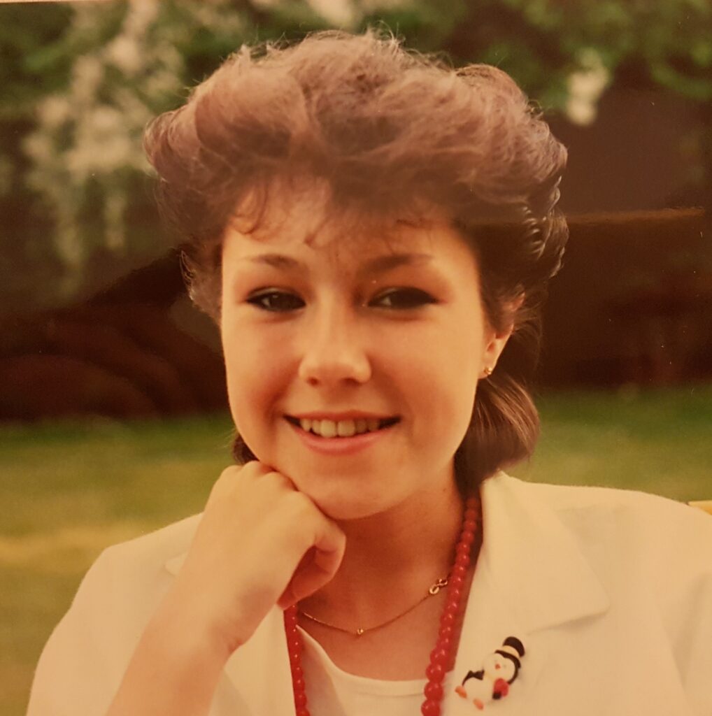 Photo of a young woman with extremely 80s short hair