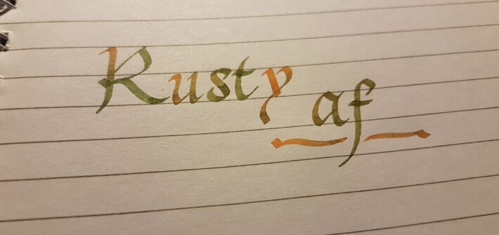 Image of lined paper with the words Rusty A F written in calligraphy
